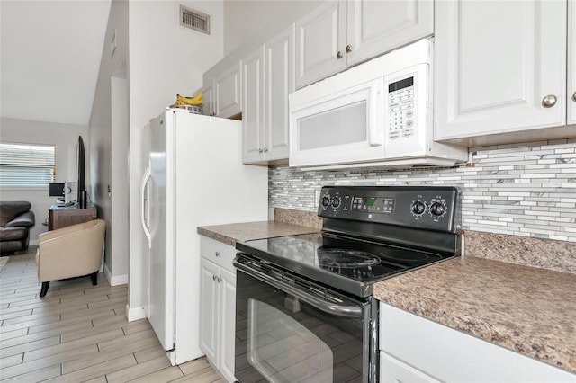 kitchen featuring white appliances, visible vents, light wood-style flooring, decorative backsplash, and white cabinetry