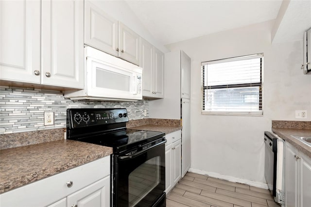 kitchen with black electric range oven, backsplash, white cabinetry, dishwashing machine, and white microwave