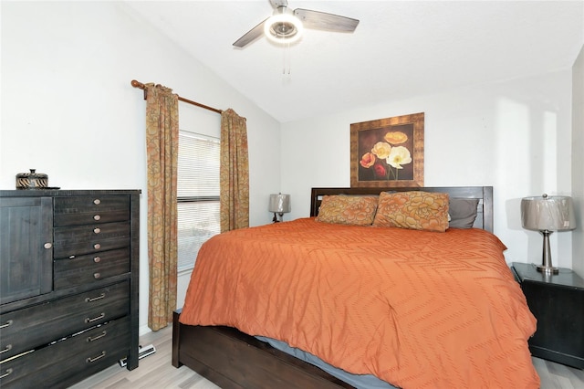 bedroom featuring lofted ceiling, a ceiling fan, and light wood finished floors