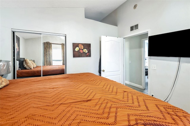 unfurnished bedroom featuring a closet, visible vents, and vaulted ceiling