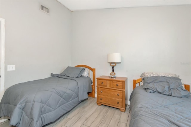 bedroom featuring light wood-style flooring and visible vents