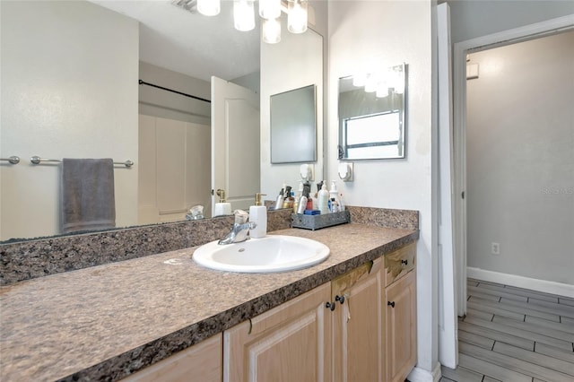 bathroom featuring baseboards and vanity