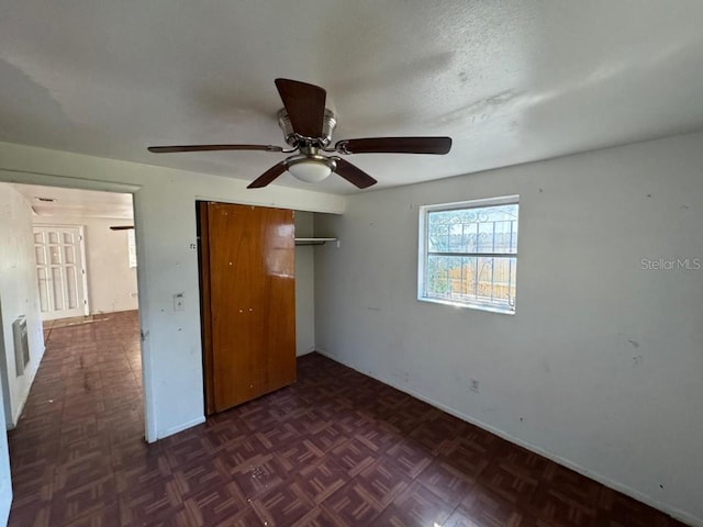 unfurnished bedroom featuring a closet, a textured ceiling, and ceiling fan