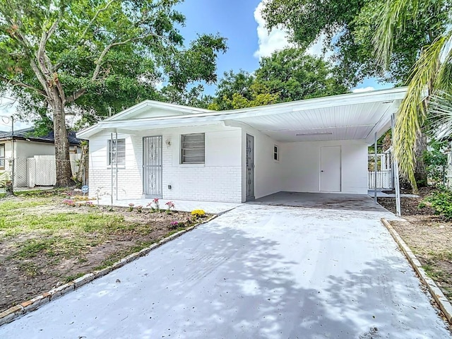 3512 N 10th St, Tampa, FL 33605 - ranch-style home with brick siding, driveway, a carport, and fence