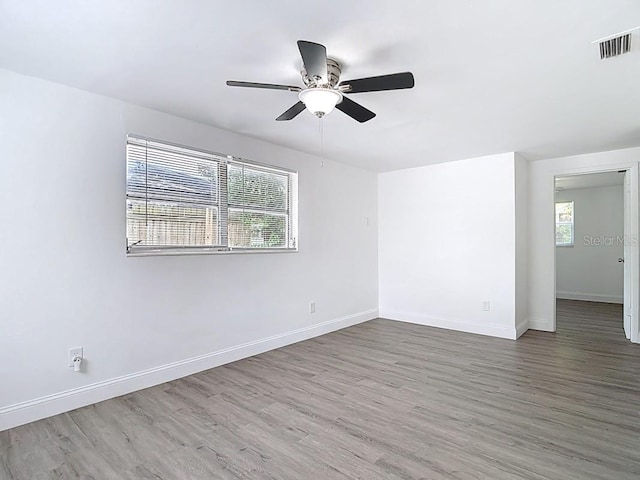 3512 N 10th St, Tampa, FL 33605 - unfurnished room with wood finished floors, visible vents, baseboards, and ceiling fan