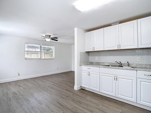 3512 N 10th St, Tampa, FL 33605 - kitchen featuring a sink, baseboards, backsplash, ceiling fan, and light countertops