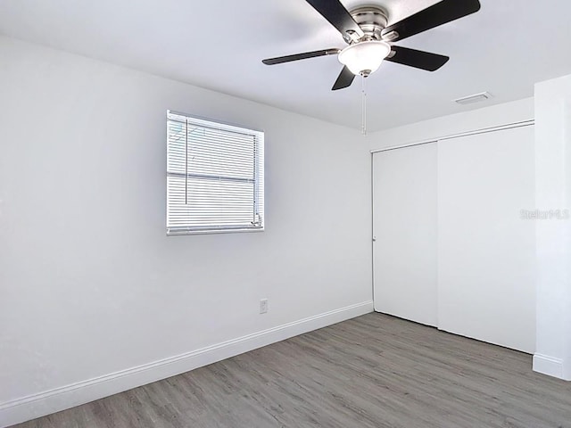 3512 N 10th St, Tampa, FL 33605 - unfurnished bedroom with wood finished floors, a closet, baseboards, and visible vents