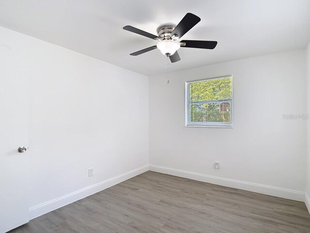 3512 N 10th St, Tampa, FL 33605 - spare room featuring wood finished floors, baseboards, and ceiling fan