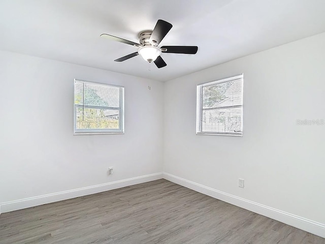 3512 N 10th St, Tampa, FL 33605 - unfurnished room with baseboards, a ceiling fan, and wood finished floors