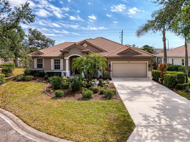 mediterranean / spanish-style house with stucco siding, a front lawn, a tile roof, and a garage