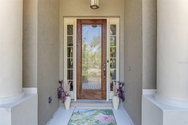 doorway to property with stucco siding