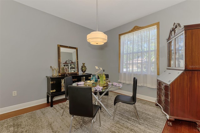 dining room featuring baseboards and wood finished floors