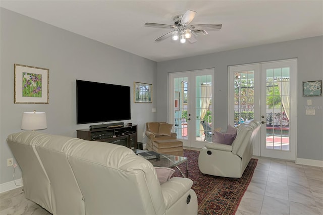 living area with french doors, baseboards, and ceiling fan