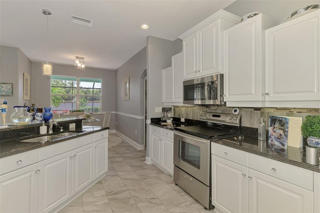 kitchen featuring visible vents, marble finish floor, a sink, appliances with stainless steel finishes, and white cabinets