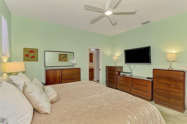 bedroom with visible vents, light colored carpet, and a ceiling fan