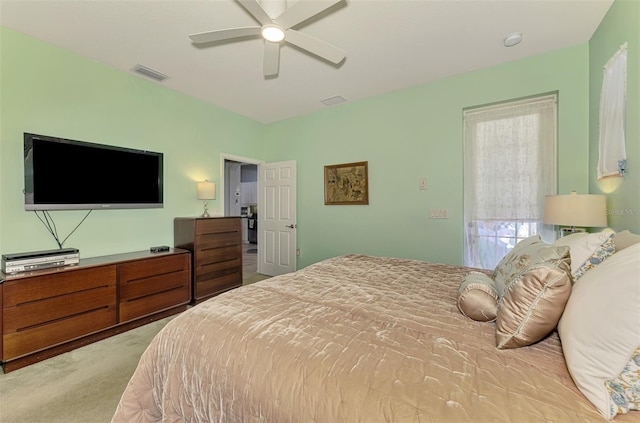 bedroom featuring a ceiling fan, visible vents, and carpet floors