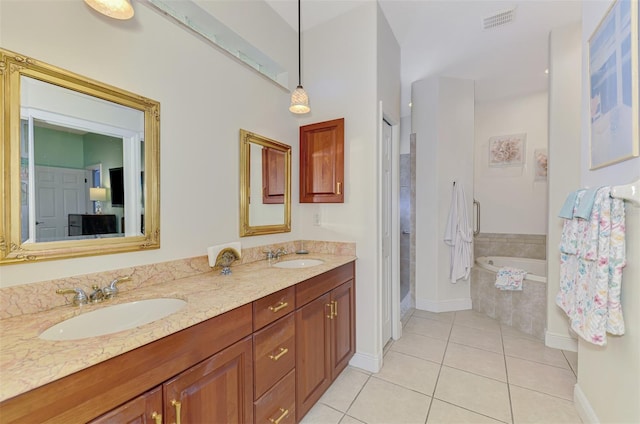 full bathroom featuring tile patterned flooring, visible vents, a bath, and a sink