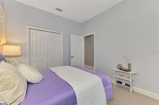 bedroom featuring carpet, visible vents, a closet, and baseboards