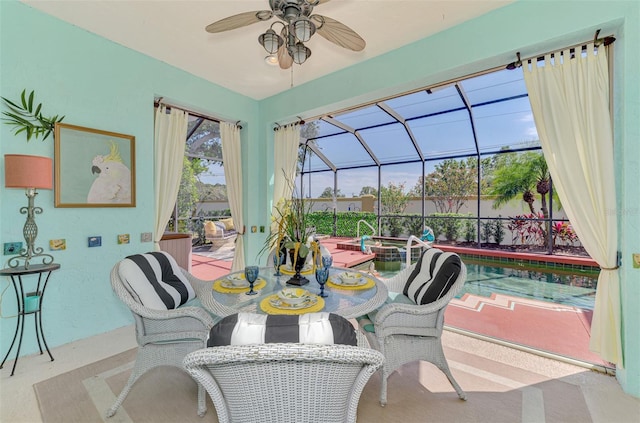 view of patio / terrace with glass enclosure, a pool with connected hot tub, outdoor dining area, and ceiling fan