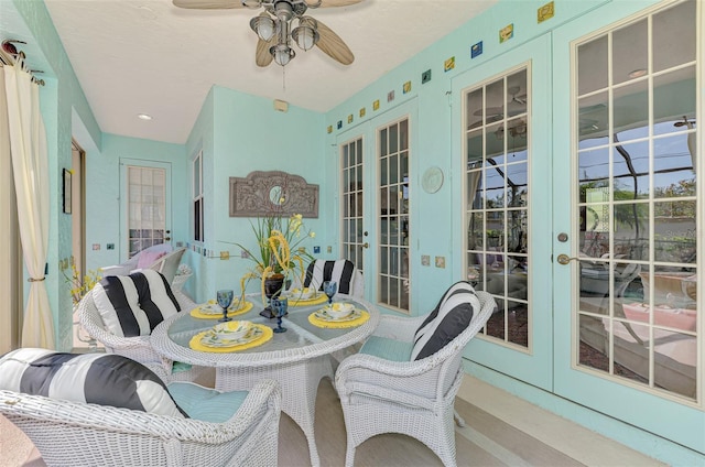 sunroom featuring french doors and a ceiling fan