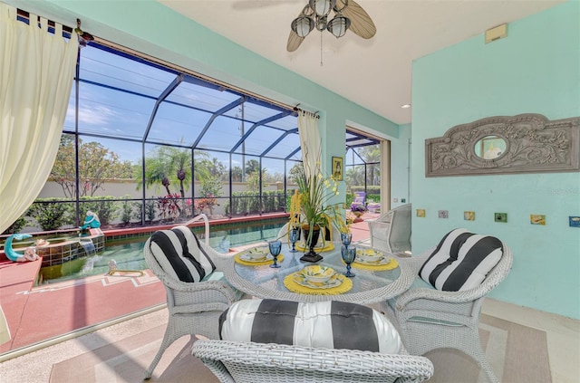 exterior space with a lanai, ceiling fan, outdoor dining space, and a pool with connected hot tub