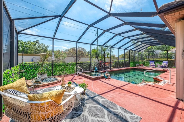 view of swimming pool featuring a lanai, a patio area, and a pool with connected hot tub