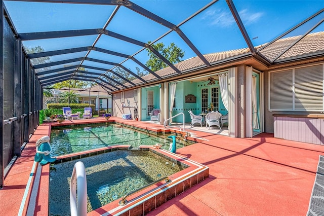 view of swimming pool with a ceiling fan, a pool with connected hot tub, french doors, a lanai, and a patio area