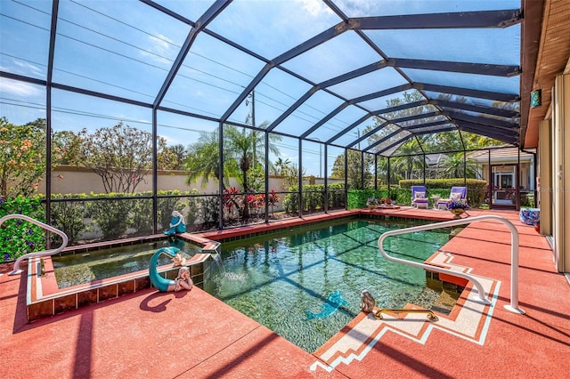 view of pool with a patio area, glass enclosure, and a pool with connected hot tub