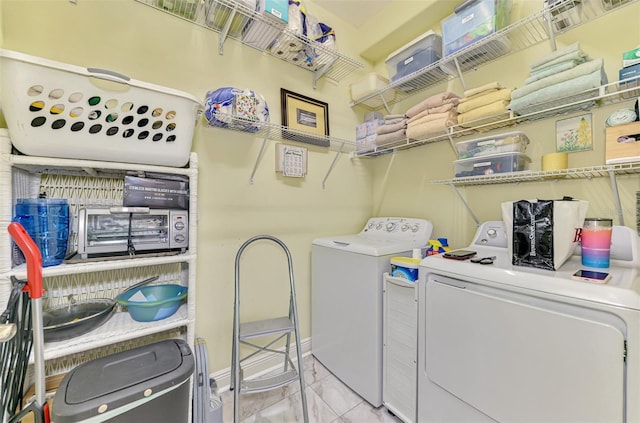 107 Wayforest Dr, Venice, FL 34292 - clothes washing area featuring washer and clothes dryer, laundry area, marble finish floor, and baseboards