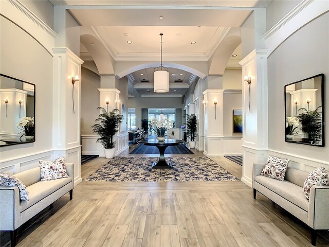 107 Wayforest Dr, Venice, FL 34292 - foyer with decorative columns, arched walkways, light wood-style floors, and a decorative wall
