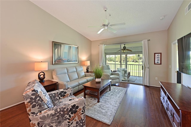 living area with visible vents, a ceiling fan, a textured ceiling, dark wood-style flooring, and vaulted ceiling