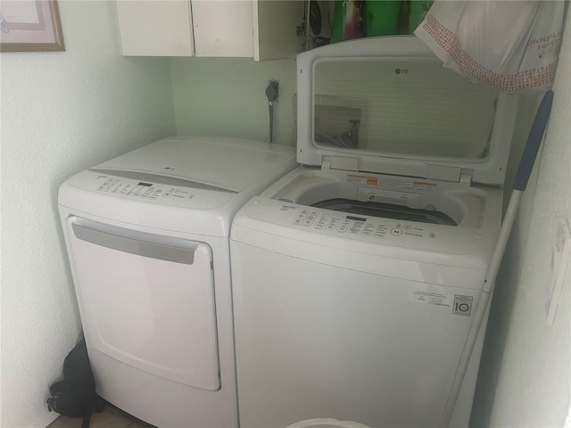 laundry room featuring washer and dryer and cabinet space