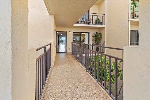 property entrance with a balcony and stucco siding