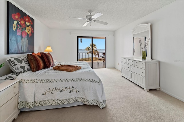 bedroom featuring light carpet, a textured ceiling, a ceiling fan, and access to outside