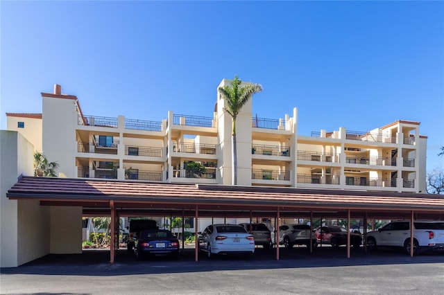 view of building exterior with covered parking