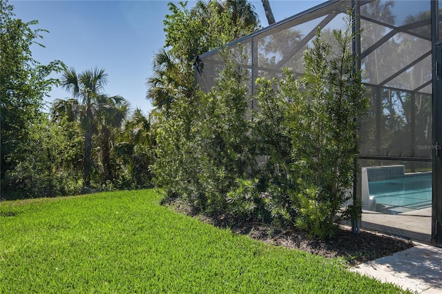 5621 Badini Way, Palmetto, FL 34221 - view of green lawn with glass enclosure and an outdoor pool