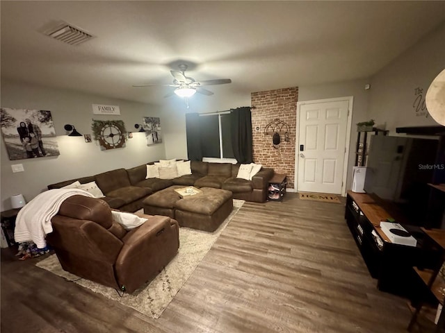 living area featuring visible vents, ceiling fan, and wood finished floors