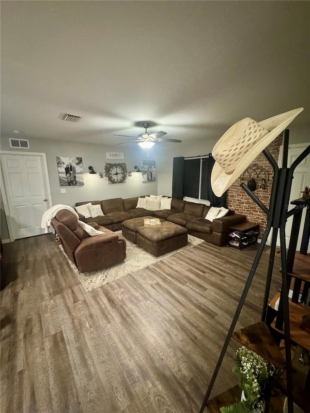 living area featuring dark wood finished floors, visible vents, and a ceiling fan