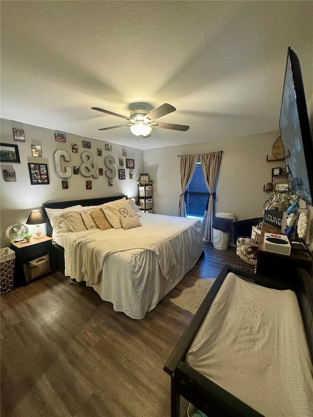 bedroom with a textured ceiling, a ceiling fan, and wood finished floors