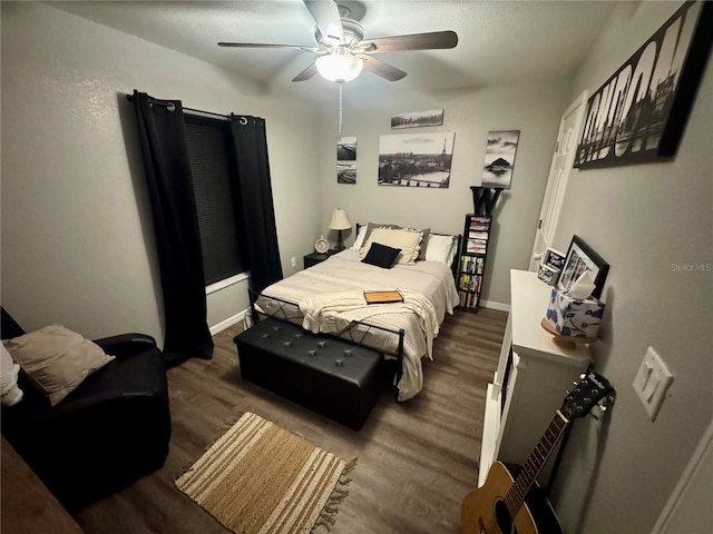 bedroom with wood finished floors, baseboards, and ceiling fan