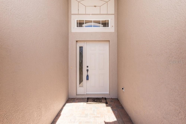 property entrance featuring stucco siding