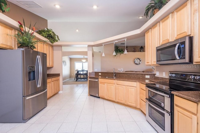 kitchen with visible vents, arched walkways, light brown cabinetry, and stainless steel appliances