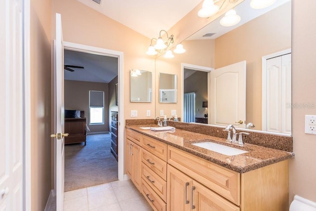 ensuite bathroom featuring double vanity, visible vents, ensuite bathroom, and a sink