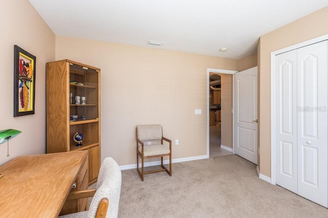 home office featuring visible vents, light colored carpet, and baseboards