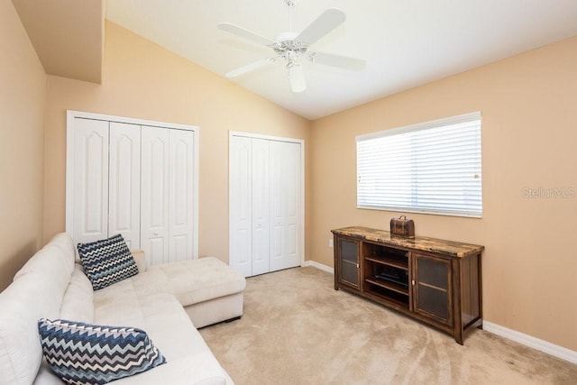 sitting room with baseboards, light colored carpet, a ceiling fan, and vaulted ceiling