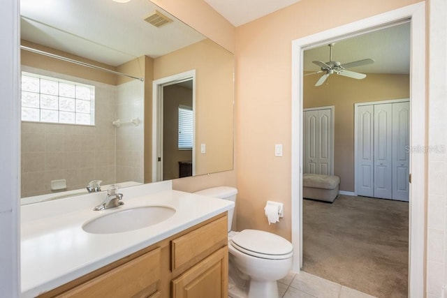 bathroom featuring vanity, a ceiling fan, visible vents, a shower, and toilet