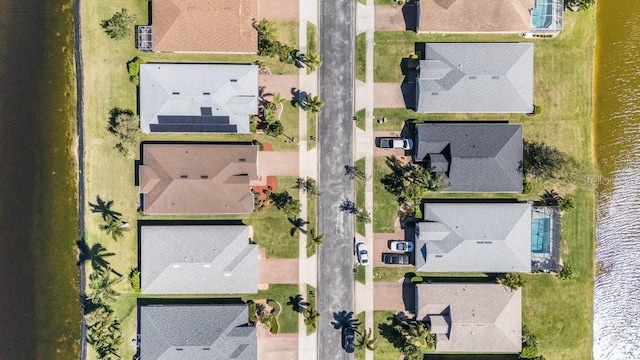 bird's eye view with a residential view and a water view