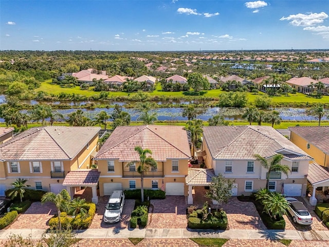 drone / aerial view featuring a residential view and a water view