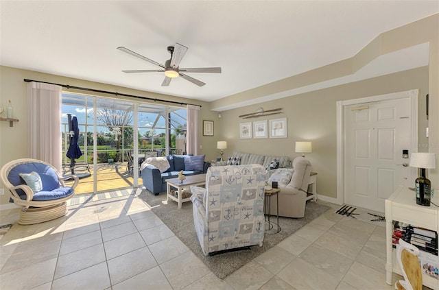 living room featuring tile patterned flooring, baseboards, and a ceiling fan