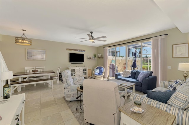 living area with light tile patterned floors and ceiling fan